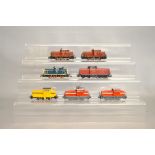 Seven Marklin HO Diesel and Electric engines, five in red livery and two others. Including three