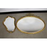 An early 20th century oval wall mirror, bevelled plate in a gilded wooden frame with ribbon