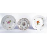 A pair of German Meissen porcelain plates with central floral sprays, moulded rims and cavettos,