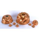 Two 19th Century copper jelly moulds, circular with swirl designs, together with three smaller