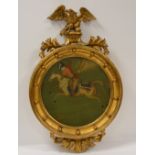 19th Century, oil on board, Moghul Warrior on horseback in circular frame with eagle motif, 40cm