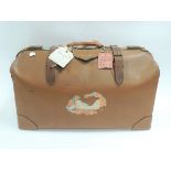 A 20th Century leather case with various traveller's labels to include Cunard Line tag, tan