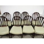 A set eight late 19th Century Hepplewhite style mahogany dining chairs, carved round backs with a