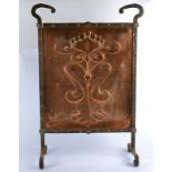 An early 20th Century Art Nouveau style wrought iron and beaten copper fire screen, of rectangular