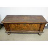 An antique continental fruitwood cassone, rising moulded top, inlayed olive wood front panels,