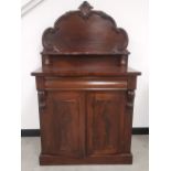 A Victorian mahogany chiffonier, shaped back with applied carving, a shelf supported by two turned