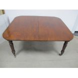 A 19th Century mahogany dining table, drawer leaf action, rounded top with two extra leaves,