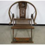 A late 19th Century Chinese Huanghuali horseshoe-back folding arm chair, The chair with a rounded