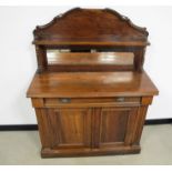 A Victorian walnut mirror backed chiffonier, shaped back with shelf supported by two turned