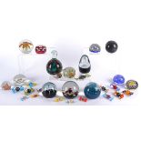 Fourteen glass paperweights, including examples by Selkirk, Murano, Caithness and more, in