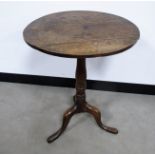 An antique oak circular snap top tripod table, 49cm, diameter height 65cm