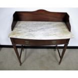 A late 19th Century mahogany bow front washstand, marble top, shaped mahogany splash back, long