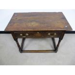 An antique oak and elm side table, two plank top, frieze drawer, raised on round turned supports,