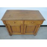 A 19th Century continental oak side cabinet, moulded top, two short frieze drawers with two panelled