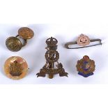 A collection of military cap badges, comprising a chrome, enamel and mother of pearl Border Reg
