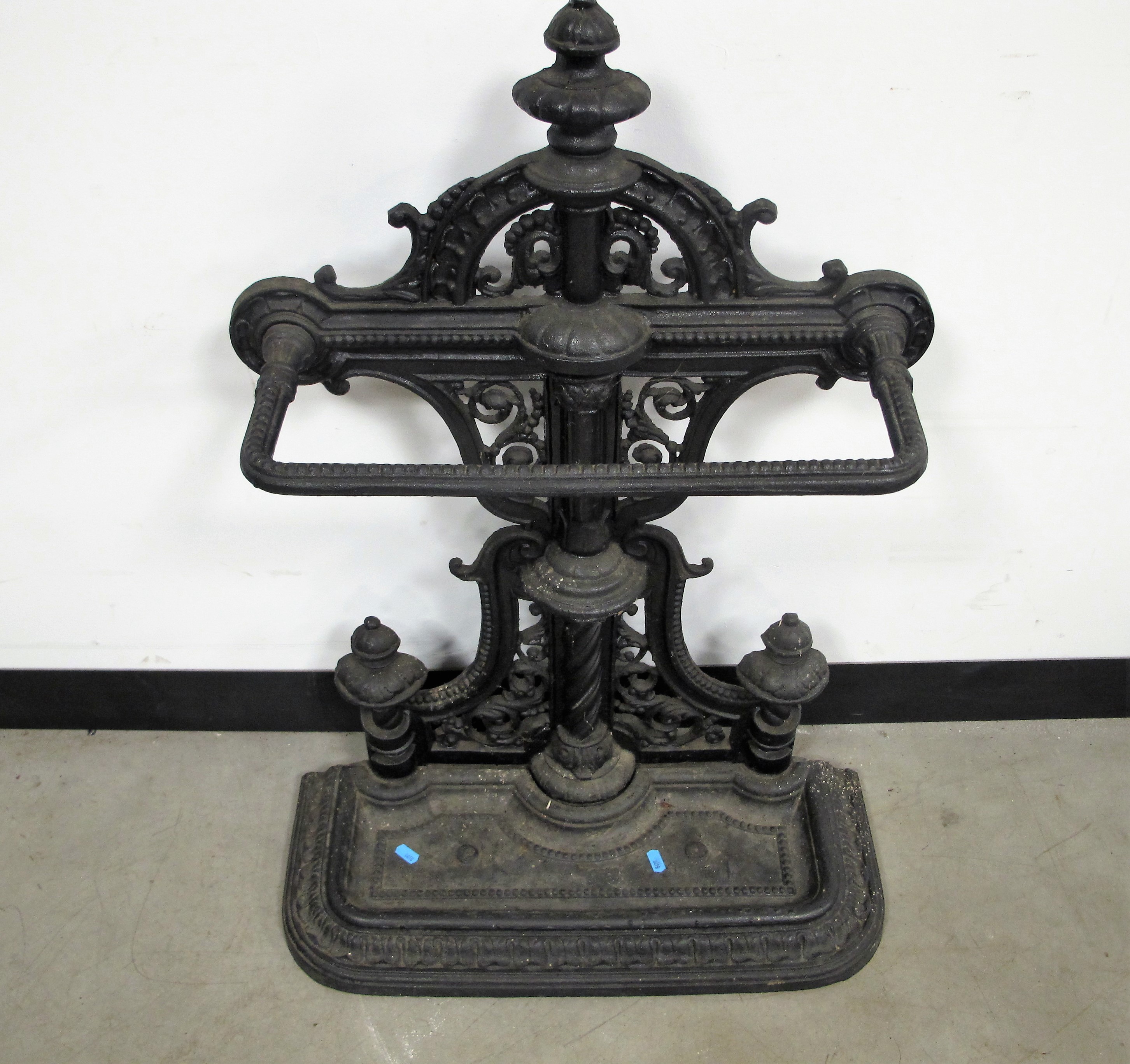 A Victorian style cast iron stick stand, elaborate pierced design to back and a lift out drip