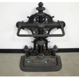 A Victorian style cast iron stick stand, elaborate pierced design to back and a lift out drip