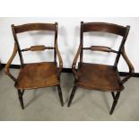 A pair of 19th Century blade back country kitchen arm chairs, elm seats, raised on turned supports