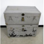 Two vintage metal bound travel trunks, both with lined interiors, lift out trays and leather