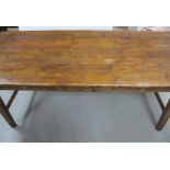 An antique pine county kitchen table, four plank top with cleated ends, two frieze drawers to one