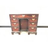 A Queen Anne Style kneehole desk, having single long drawer over central single cupboard, flanked by