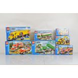 Seven boxed Lego City models, including Heavy Hauler 7998 opened and unchecked, City Truck 3221