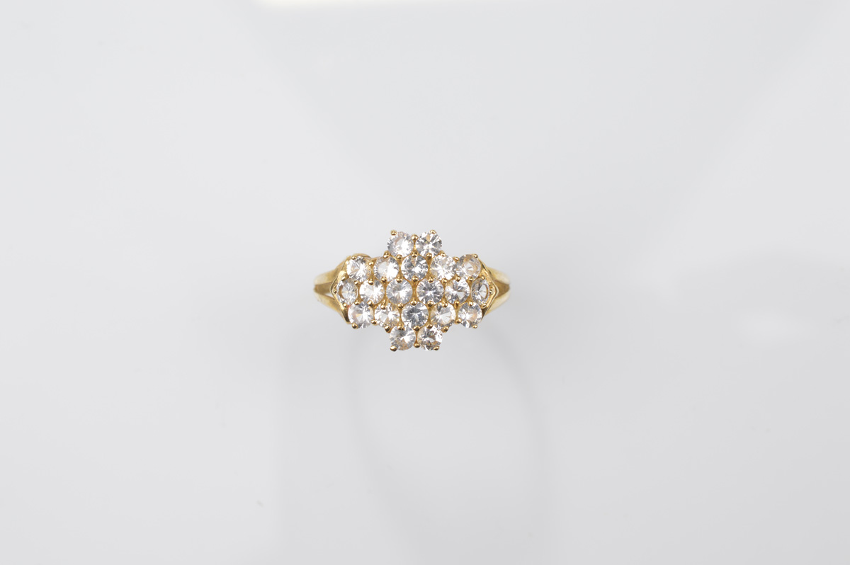 A certificated 9ct gold white sapphire dress ring, the round cuts in a thick cruciform setting