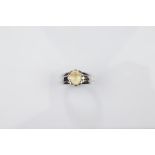 A certificated 9ct gold gentleman's gem set signet ring, white gold setting and shank surmounted