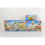 Three boxed Lego City models, Service Station 60132, Burger Bar Fire Rescue 60214 and Repair Truck