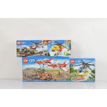Four boxed Lego City models, including Airport Air Show 60103, Helicopter Pursuit 60067, Heavy Cargo