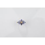 A certificated 18ct gold Ceylon sapphire and diamond dress ring, the flower setting with central