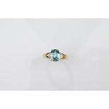 A certificated 9ct gold single stone blue zircon dress ring, mixed oval cut in claw setting, all