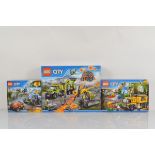 Three boxed Lego City models, including Volcano Exploration Base 60124 opened with manuals and