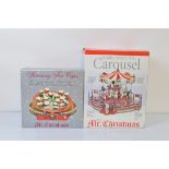 Original Classics by Mr Christmas, Spinning Tea Cups and Holiday Around the Carousel, both boxed (2)