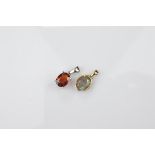 Two certificated 9ct gold gem set pendants, comprising an oval mixed cut labradorite and spessartite