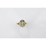 A certificated 9ct gold green amethyst dress ring, oval cut with cabochon table and cut pavilion