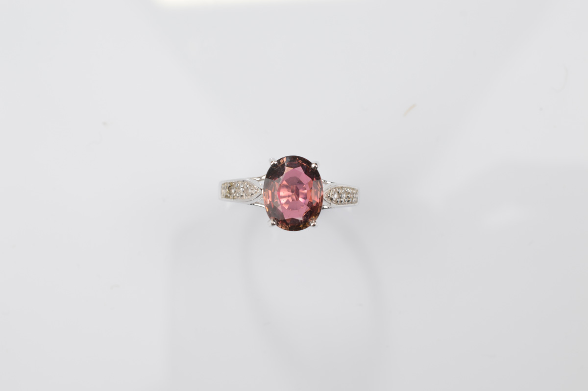 A certificated 9ct gold tourmaline and white topaz dress ring, the oval burgundy coloured mixed