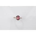 A certificated 9ct gold tourmaline and white topaz dress ring, the oval burgundy coloured mixed