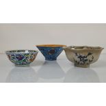 Three Chinese porcelain bowls, the first with doucai style enamel work with phoenixes and nuyi