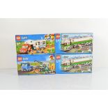 Four boxed Lego City models, Harvester Transport 60223, unopened, Pickup and Caravan 60182,