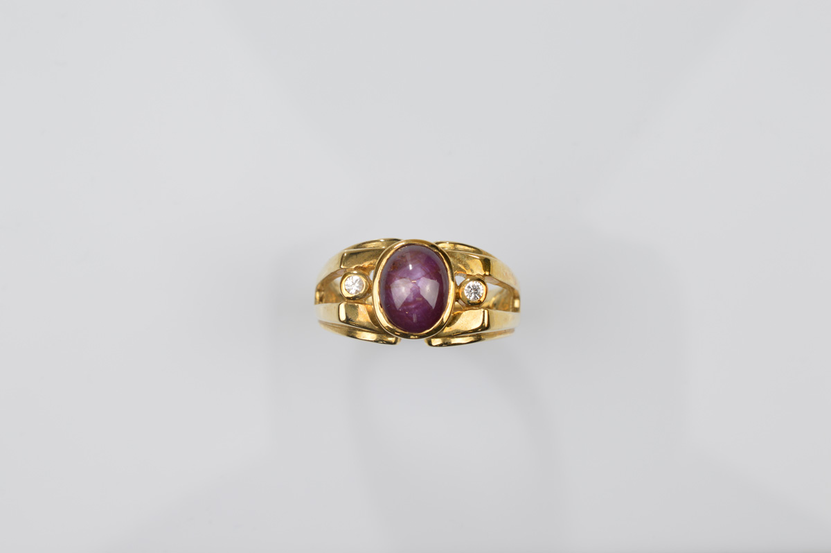 A certificated 9ct gold star ruby and white sapphire gentleman's dress ring, the central cabochon