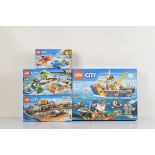 Four boxed Lego City models, including Deep Sea Exploration Vessel 60095 opened with manual