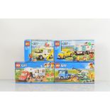 Four boxed Lego City models, including Pickup and Caravan 60182, Harvester Transport 60223, Car