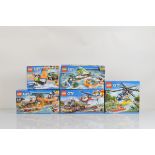 Five boxed Lego City models, including Helicopter Pursuit 60067, Pickup and Caravan 60182, 4 x 4