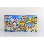 Three boxed Lego City models, all unopened, Donut Shop 60233, Fun at the Beach 60153 and Fun in