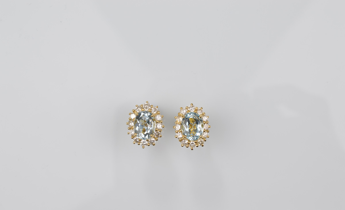 A pair of 18ct gold aquamarine and diamond cluster ear studs, oval mixed cut aquamarines