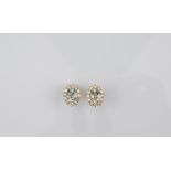 A pair of 18ct gold aquamarine and diamond cluster ear studs, oval mixed cut aquamarines