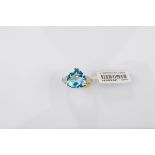A certificated 9ct gold Swiss blue topaz and diamond dress ring, the trilliant claw set blue topaz