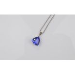 An 18ct gold tanzanite drop pendant, with claw set trillion cut in white gold on a fine gold