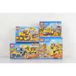 Four boxed Lego City models, including Service Truck 60073 unopened, Bulldozer 60074 unopened,